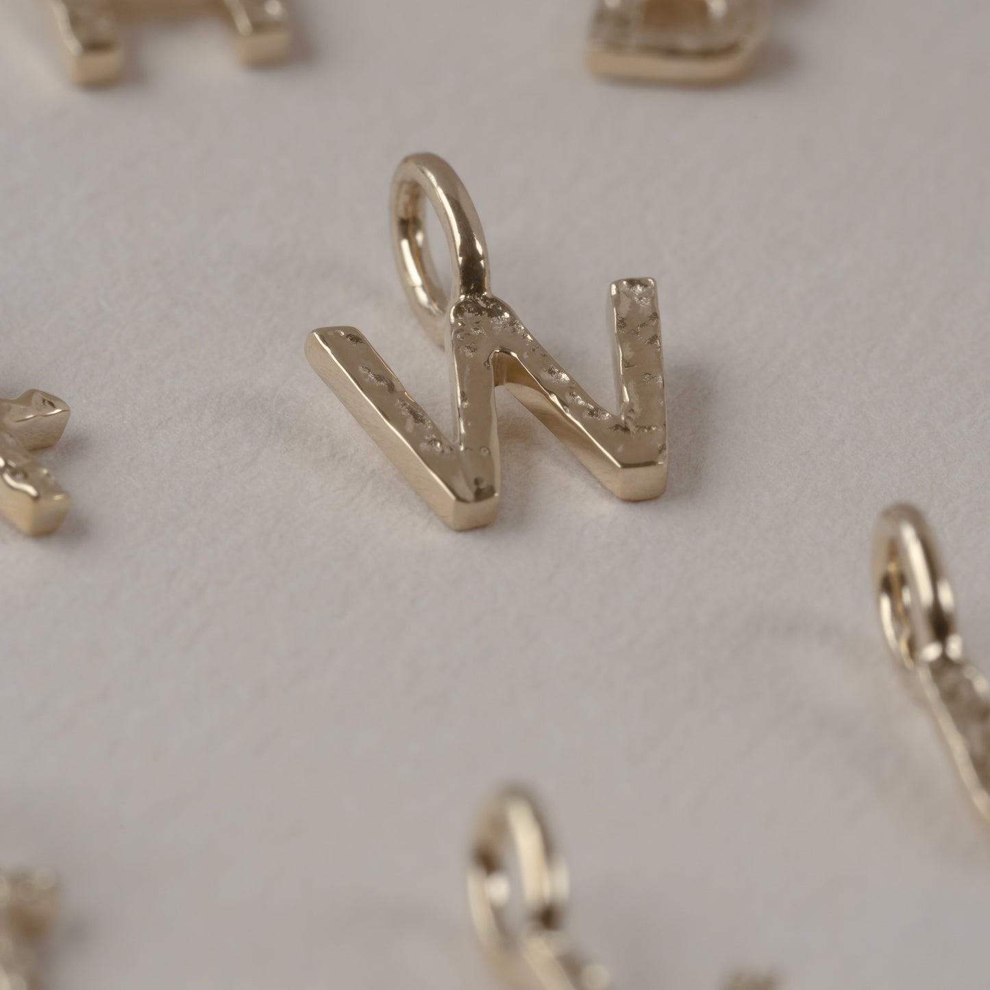 Letter Charm 375 9k solid gold massivt guld pendant vedhæng bogstav HandcraftedCPH handcrafted Copenhagen handmade Danish design molten organic texture symbol petit cute smeltet organisk bogstaver letters