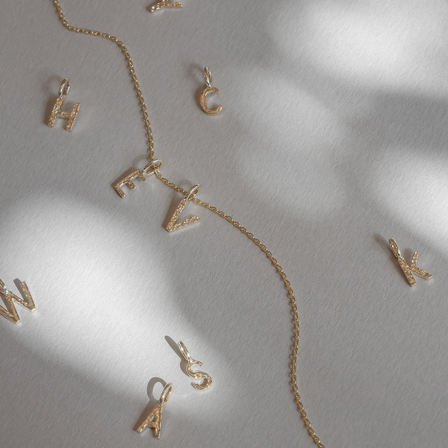 Letter Charm 375 9k solid gold massivt guld pendant vedhæng bogstav HandcraftedCPH handcrafted Copenhagen handmade Danish design molten organic texture symbol petit cute smeltet organisk bogstaver letters