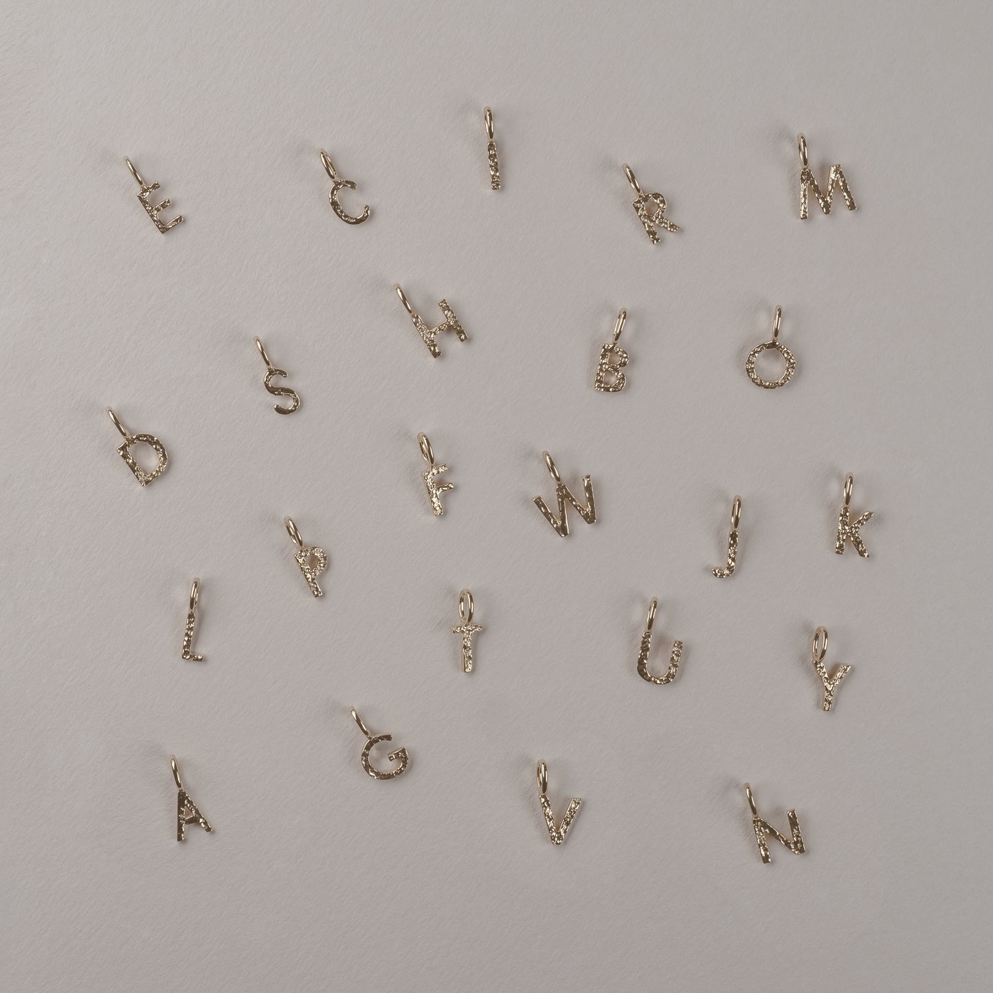 Letter Charm 375 9k solid gold massivt guld pendant vedhæng bogstav HandcraftedCPH handcrafted Copenhagen handmade Danish design molten organic texture symbol petit cute smeltet organisk bogstaver letters